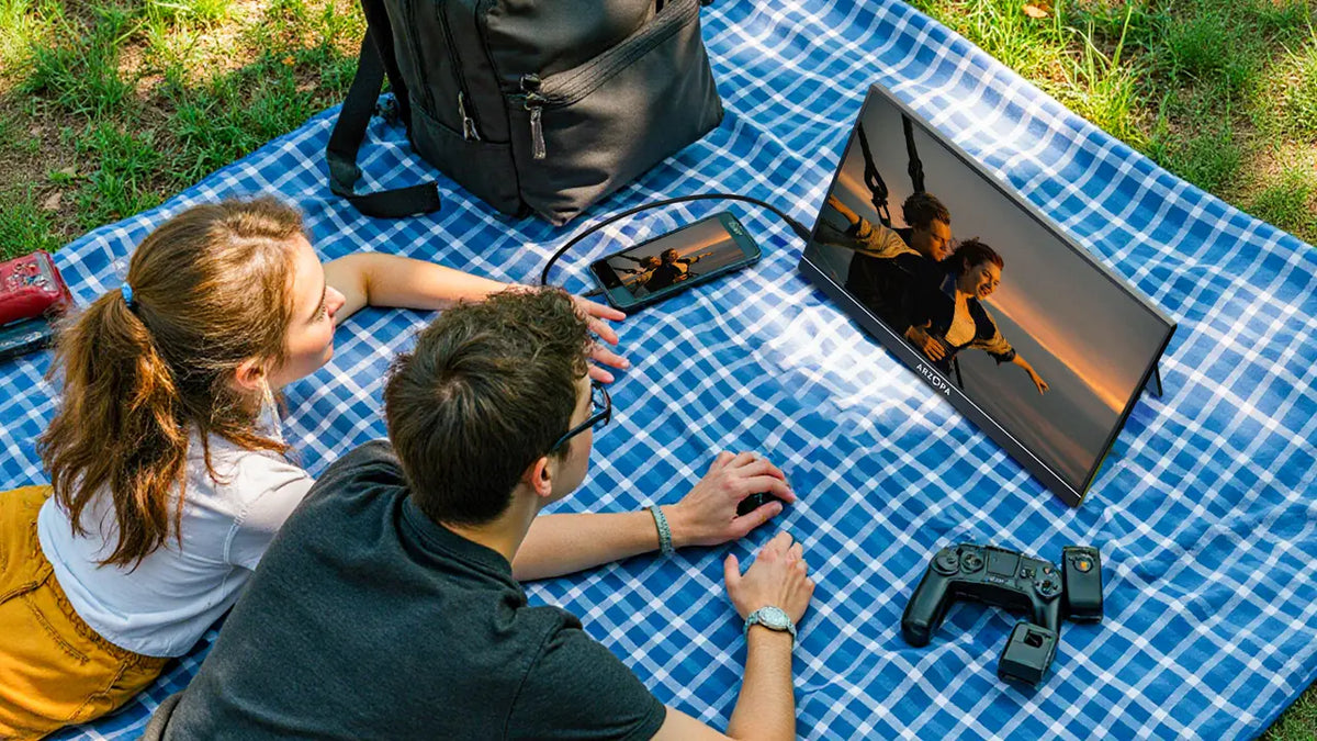 Watching a movie on a portable monitor outdoors