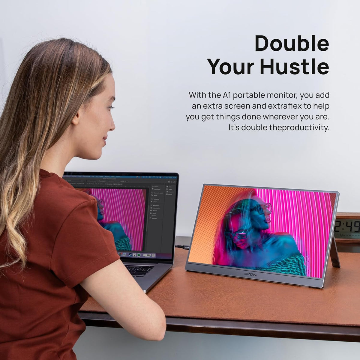 A woman using the ARZOPA A1 15.6 inch grey portable monitor as a dual screen setup with her laptop.