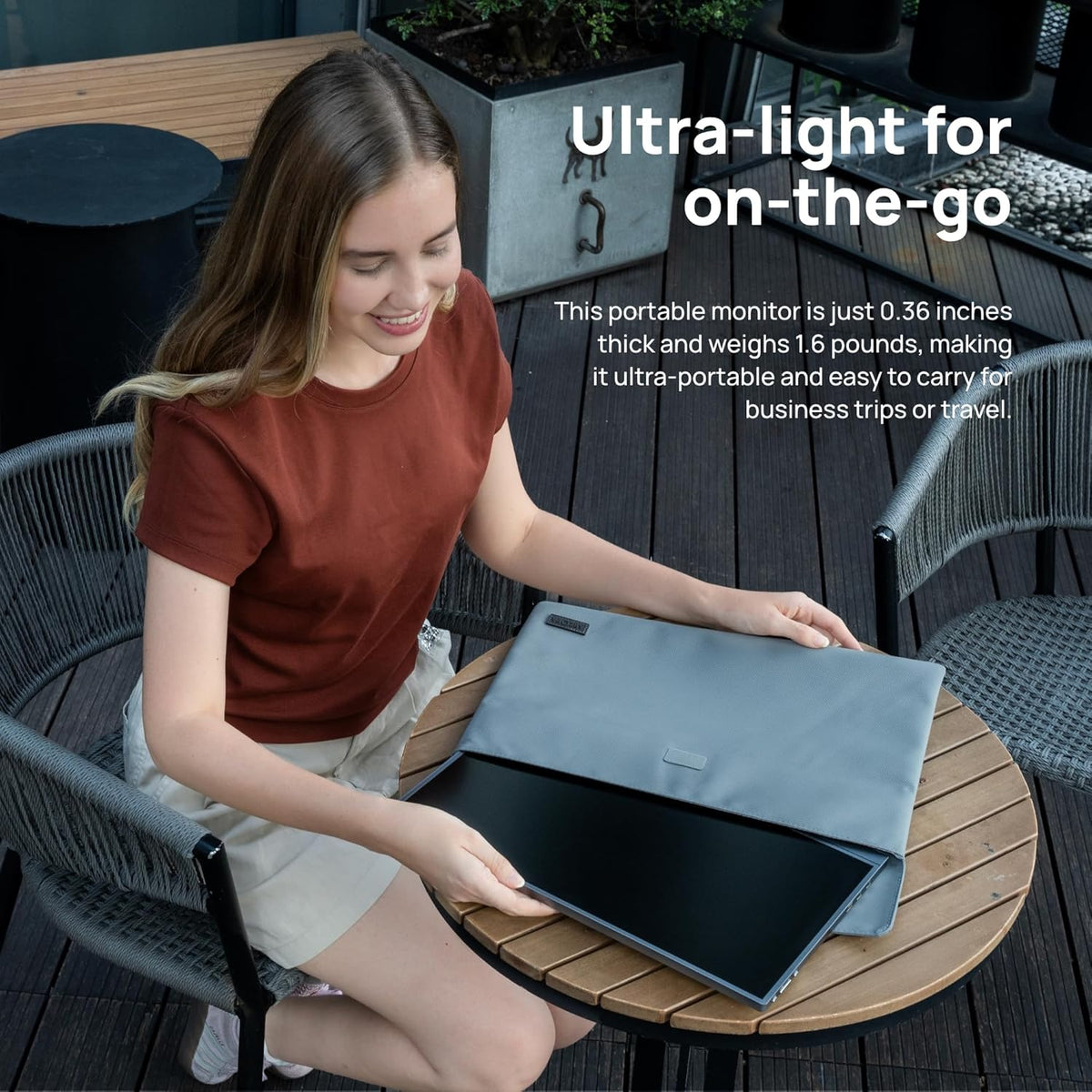 A woman packing the ultra-light ARZOPA A1 grey portable monitor into a protective smart cover sleeve case for travel.
