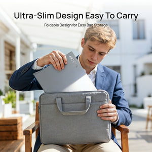 A man packing the ultra slim and foldable ARZOPA E1 dual screen portable monitor into a gray laptop sleeve bag.